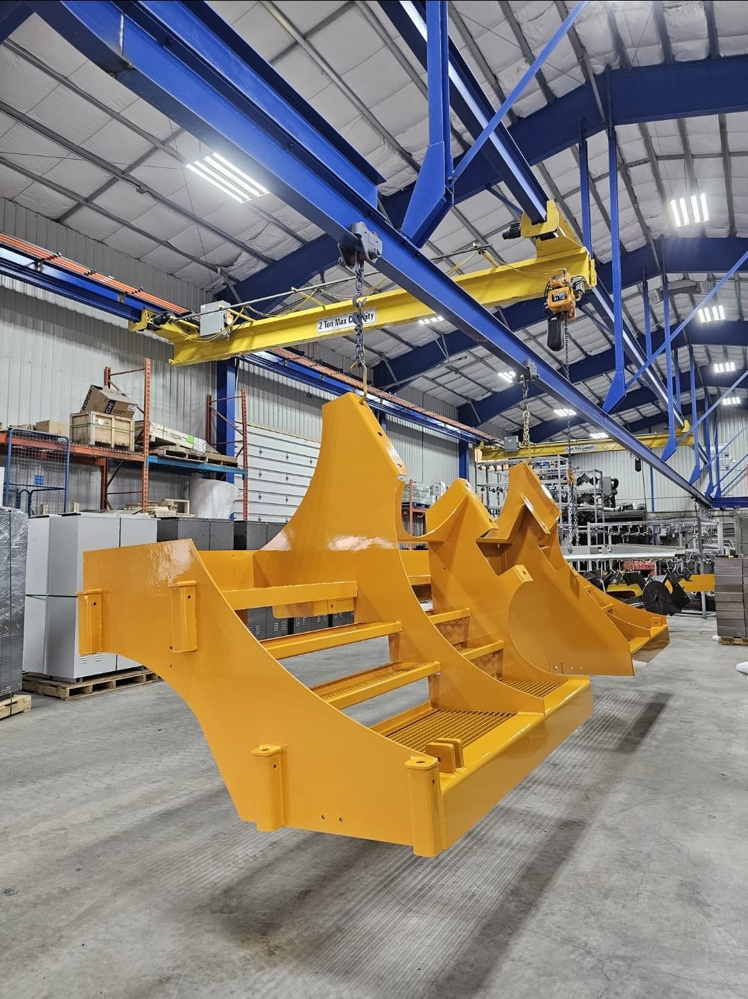 Yellow powder coated industrial fabrication inside the facility
